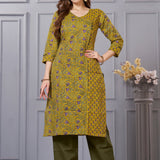 Front full length view of a model wearing a sage green cotton floral print kurta set with matching pocketed straight pants and a coordinating printed dupatta