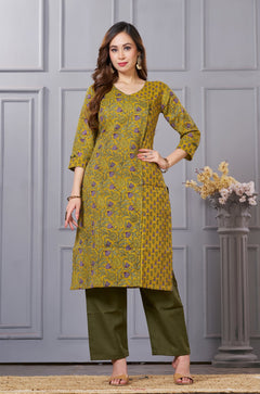 Front full length view of a model wearing a sage green cotton floral print kurta set with matching pocketed straight pants and a coordinating printed dupatta