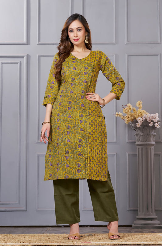 Front full length view of a model wearing a sage green cotton floral print kurta set with matching pocketed straight pants and a coordinating printed dupatta