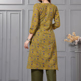 Back view of the sage green straight fit cotton floral kurta set highlighting the clean print alignment and fluid dupatta drape