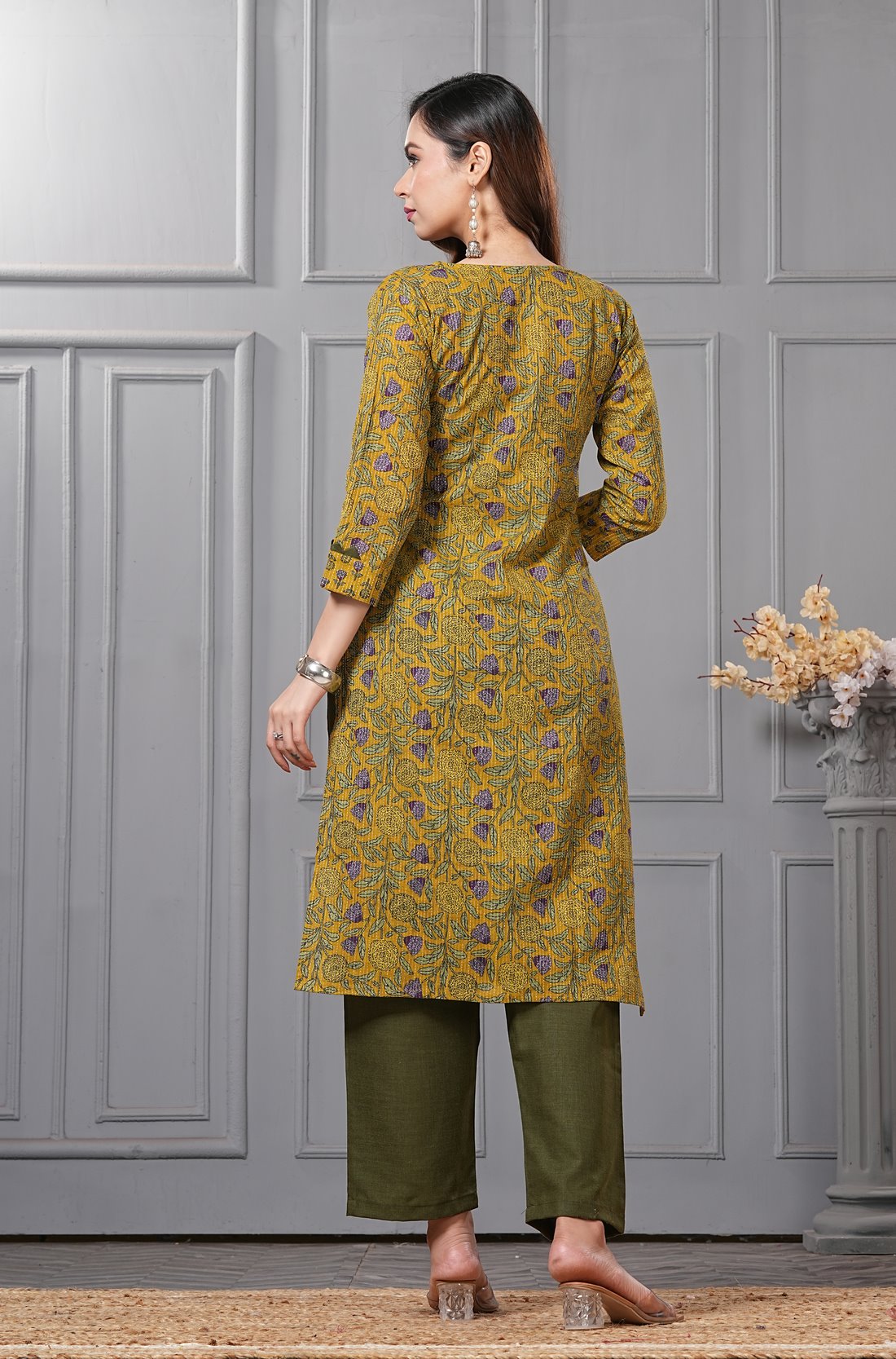 Back view of the sage green straight fit cotton floral kurta set highlighting the clean print alignment and fluid dupatta drape