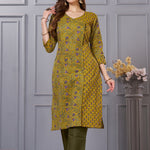 Side profile view of a model in a sage green floral printed cotton ethnic suit showcasing the regular fit and elegant side slit profile