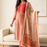 Front full length view of a woman wearing a red pashmina silk kurta set with embroidery and a dupatta