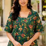 Close-up shot of the front bodice showcasing the unique overlapping V-shaped neckline and center gathering details on a dark green floral printed cotton frock kurti.