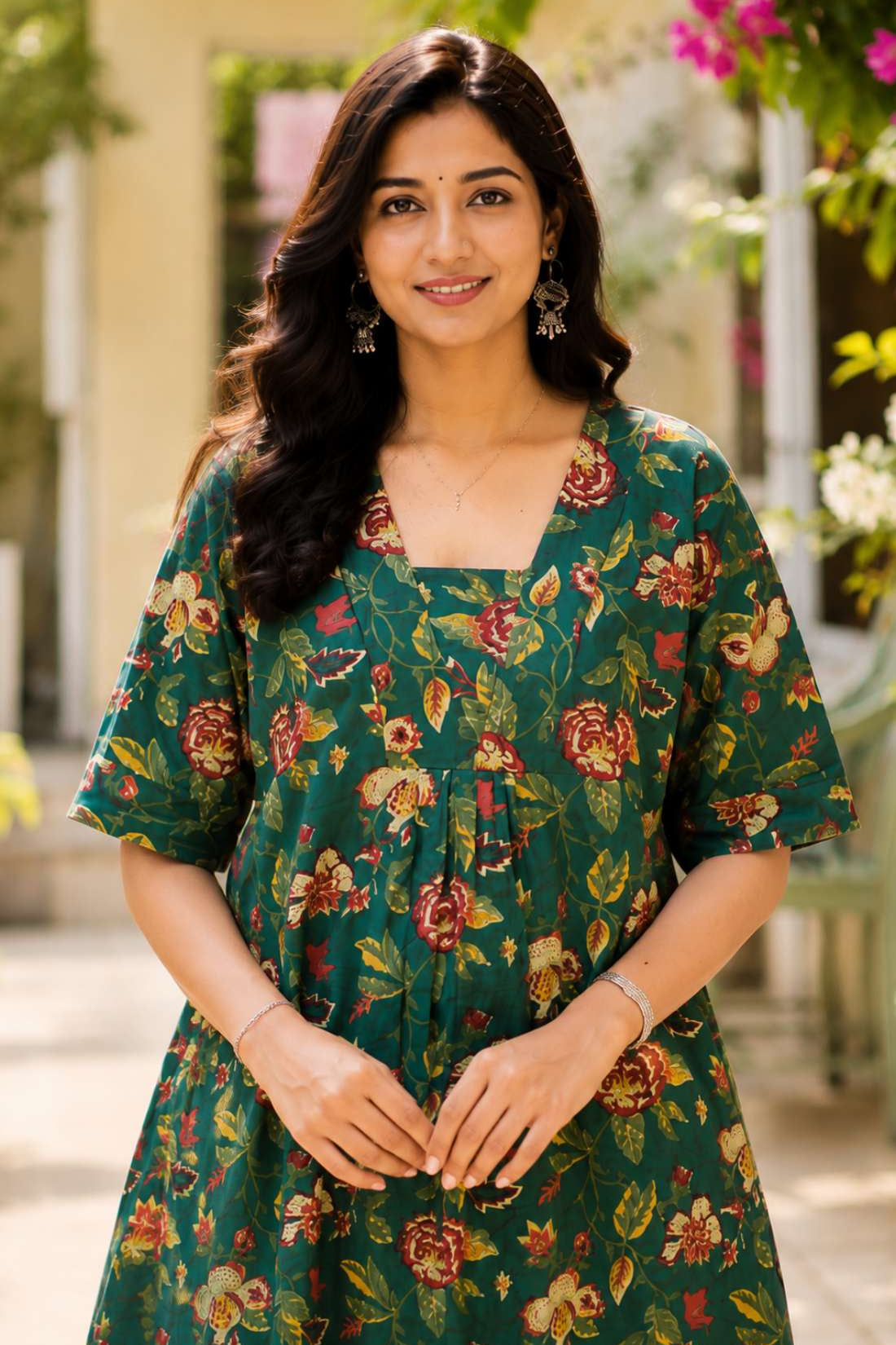 Close-up shot of the front bodice showcasing the unique overlapping V-shaped neckline and center gathering details on a dark green floral printed cotton frock kurti.