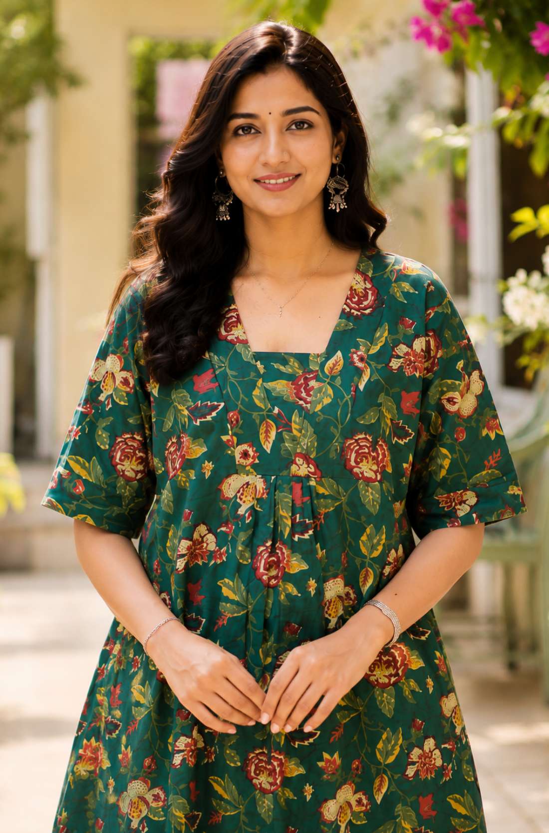 Close-up shot of the front bodice showcasing the unique overlapping V-shaped neckline and center gathering details on a dark green floral printed cotton frock kurti.