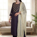 Side profile view of a woman wearing a dark purple crepe ethnic suit showcasing the clean fall of the straight pants and styled printed dupatta