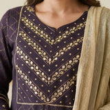 Close up shot of the intricate silver chain stitch hand embroidery patterns on the yoke and round neckline of a dark purple crepe kurta