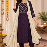 Full-length front view of a model in a free-style pose wearing a dark purple embroidered straight kurta set with a beige draped dupatta and matching trousers.