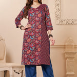 Front full length view of a model wearing a deep mudberry purple cotton floral print kurta set with matching pocketed straight pants and a coordinating printed dupatta