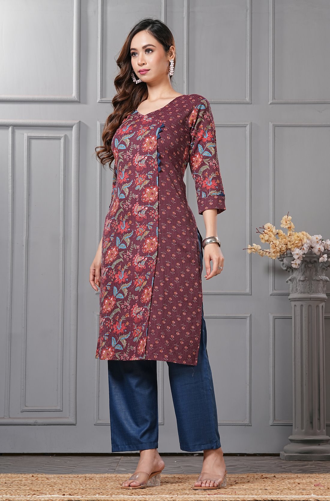Side profile view of a model in a deep mudberry purple floral printed cotton ethnic suit showcasing the regular fit and elegant dupatta drape