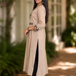 Side view of embroidered beige A-line rayon kurta with 3/4 sleeves and side slit