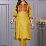Side profile view of the straight-fit ochre yellow cotton kurta showcasing the pocketed pants and beautiful matching printed dupatta drape