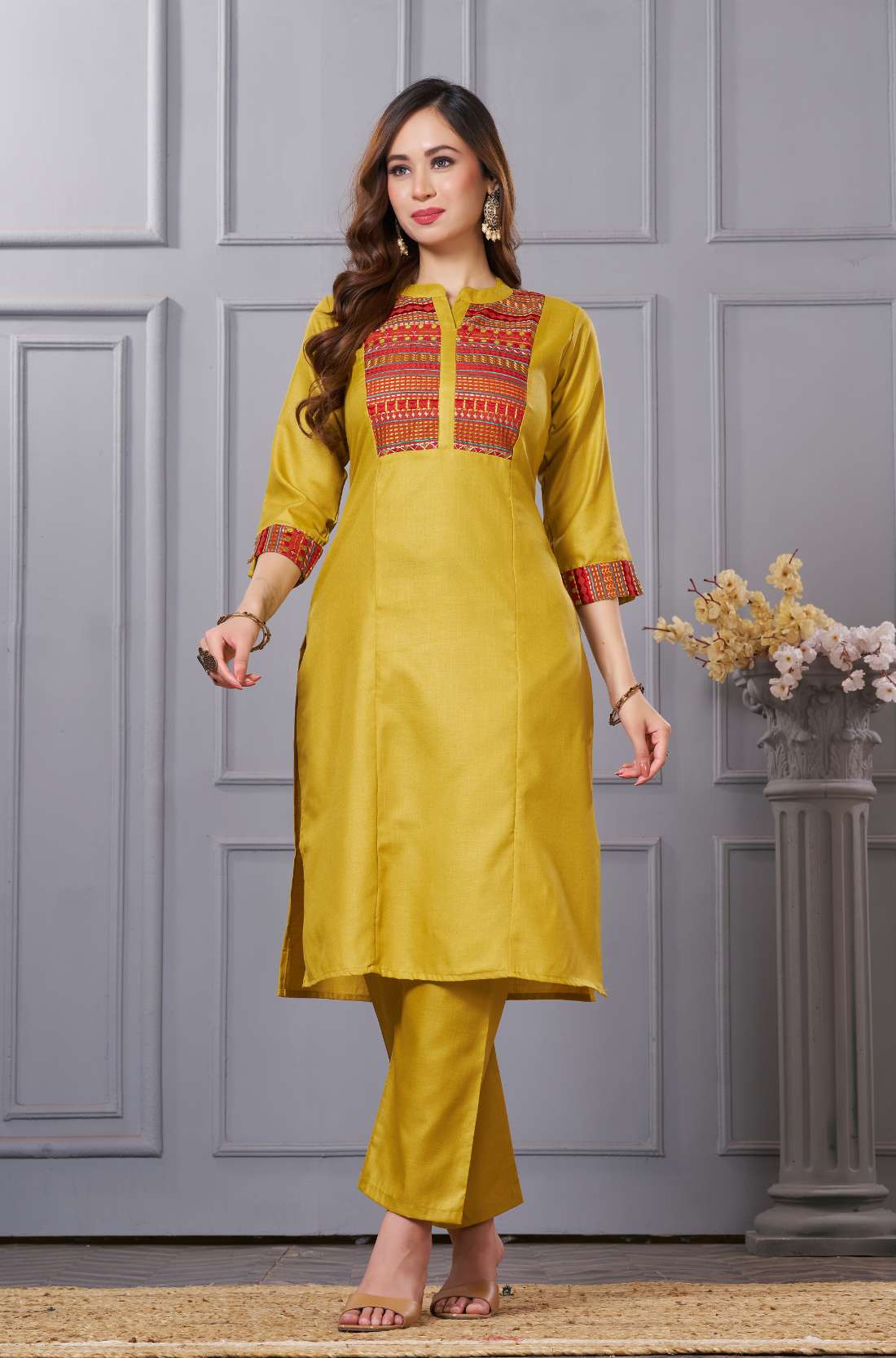 Side profile view of the straight-fit ochre yellow cotton kurta showcasing the pocketed pants and beautiful matching printed dupatta drape