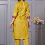 Back view of the straight fit ochre yellow cotton straight kurta set showing the comfortable trousers and clean back silhouette