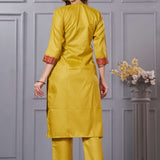 Back view of the straight fit ochre yellow cotton straight kurta set showing the comfortable trousers and clean back silhouette