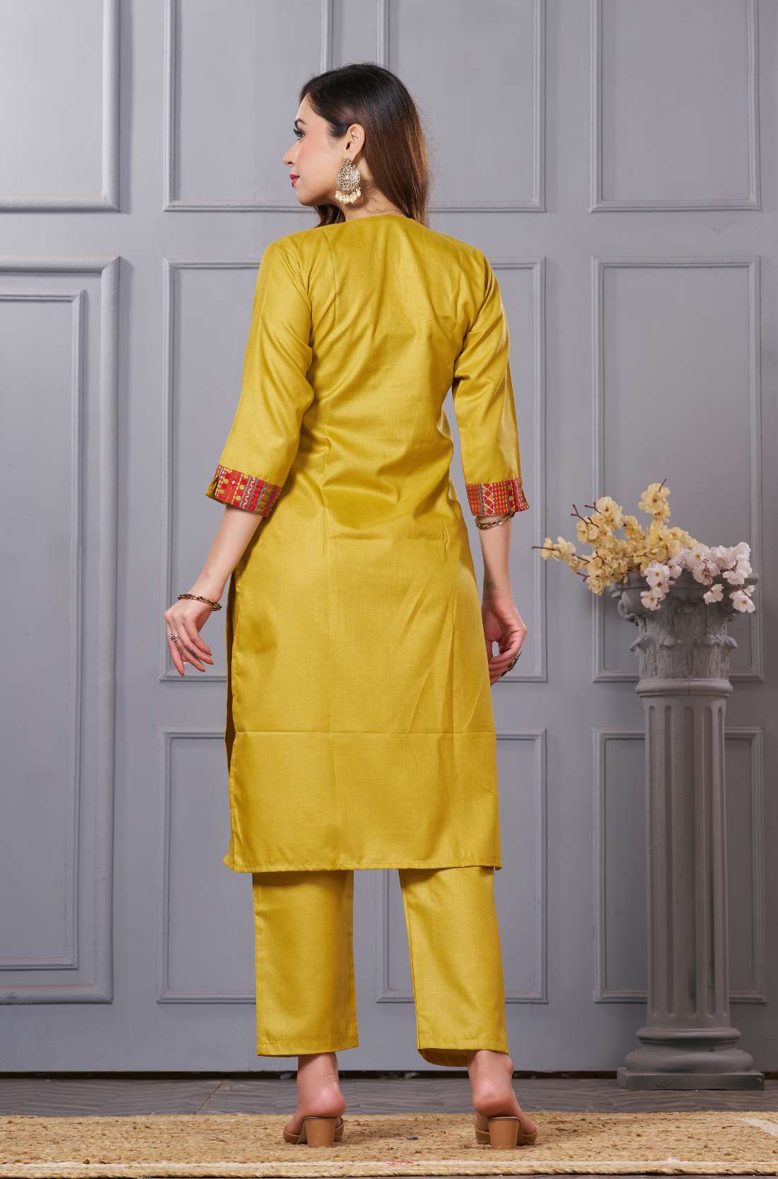 Back view of the straight fit ochre yellow cotton straight kurta set showing the comfortable trousers and clean back silhouette