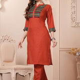 Side profile view of the straight-fit rust orange cotton kurta showcasing the pocketed pants and beautiful matching printed dupatta drape