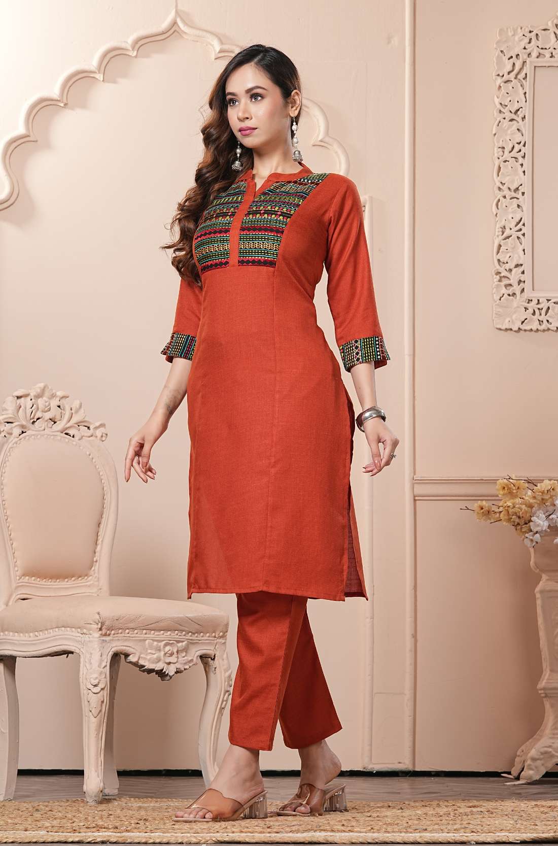 Side profile view of the straight-fit rust orange cotton kurta showcasing the pocketed pants and beautiful matching printed dupatta drape