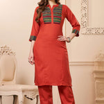 Front full length view of a model wearing an embroidered rust orange yoke cotton straight kurta set with pocketed pants and a printed dupatta
