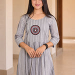 Mid-length front view of grey A-line cotton kurta showing circular embroidery and gathered waist