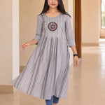 Model wearing grey A-line cotton kurta with flared hem and striped pattern, walking front view
