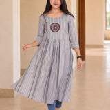 Model wearing grey A-line cotton kurta with flared hem and striped pattern, walking front view