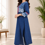 Side view of a model demonstrating the fit, side slit, and three-quarter sleeve details of the blue Indigo cotton kurti.