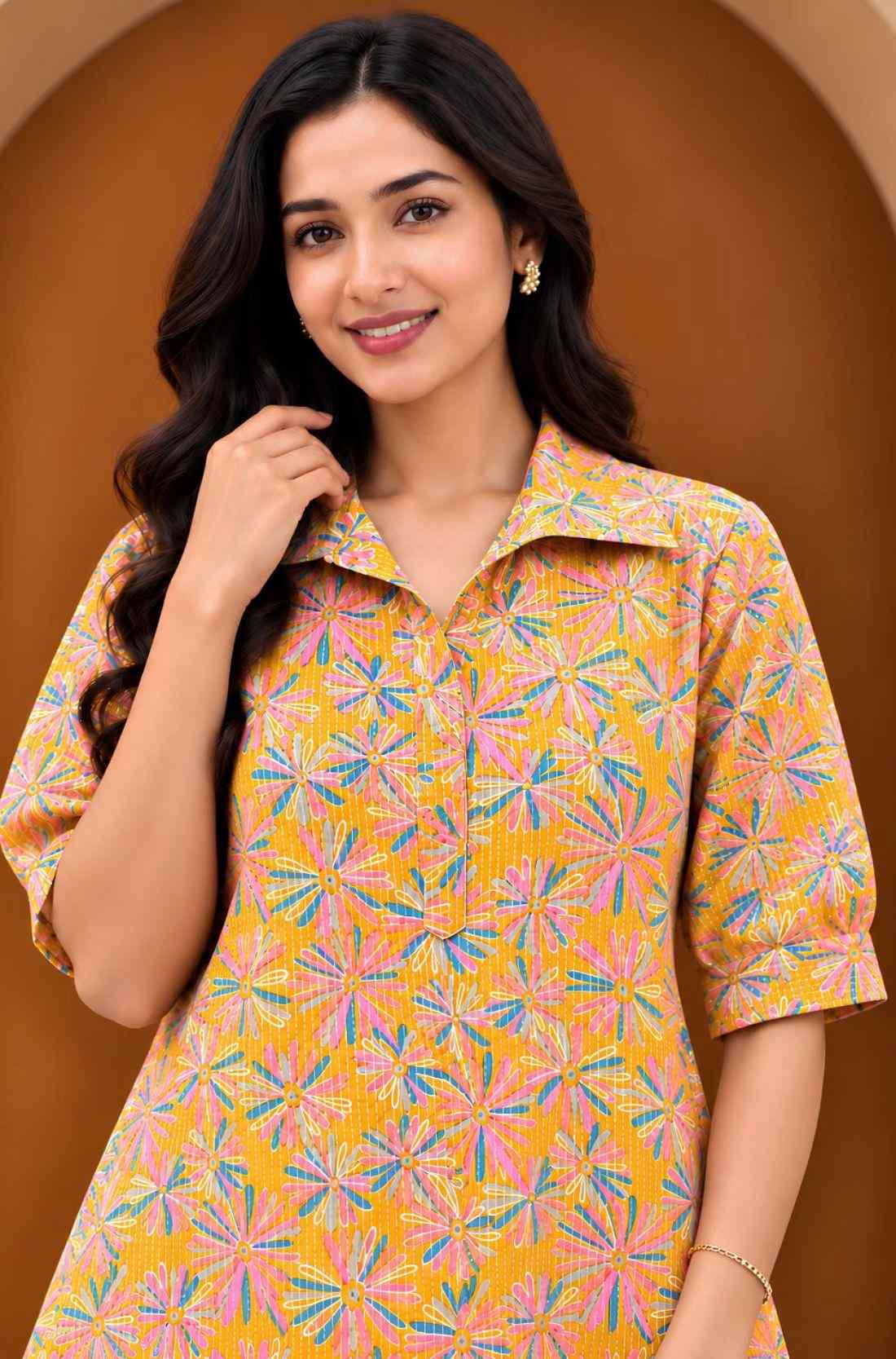 Upper-body close-up of Jaipur floral print cotton midi dress in ochre yellow with collared neckline, elbow sleeves and multicolour floral motifs.