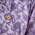 Close-up detail of lavender floral block print cotton shirt highlighting wooden buttons and handcrafted print.