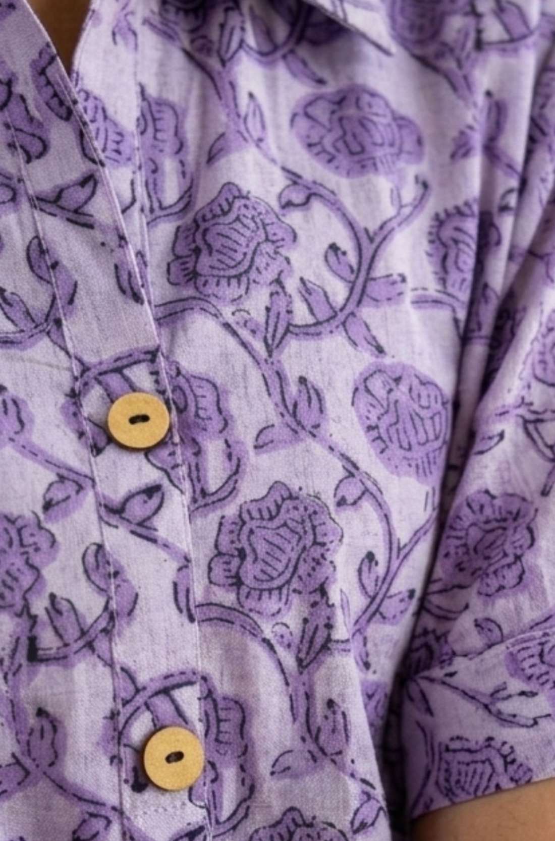 Close-up detail of lavender floral block print cotton shirt highlighting wooden buttons and handcrafted print.