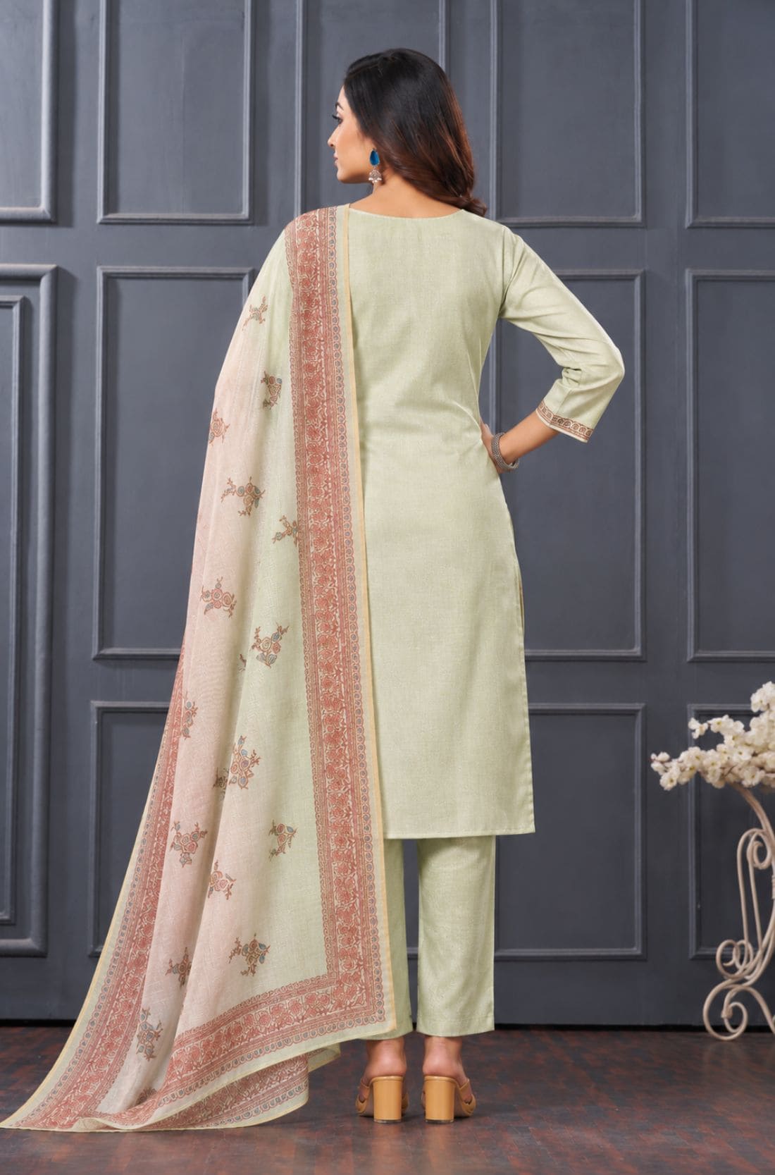 Back view of women's light green 3-piece silk blend kurta set with matching pants and printed dupatta.