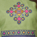 Detailed view of the intricately designed front yoke section on a light green cotton kurta featuring precise geometric and floral cross stitch needlework