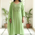 Front full length view of a woman wearing a light green embroidered kurta set with straight pants and a matching printed dupatta
