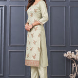 Side view of women's light green embroidered silk blend kurta set with matching pants and dupatta.