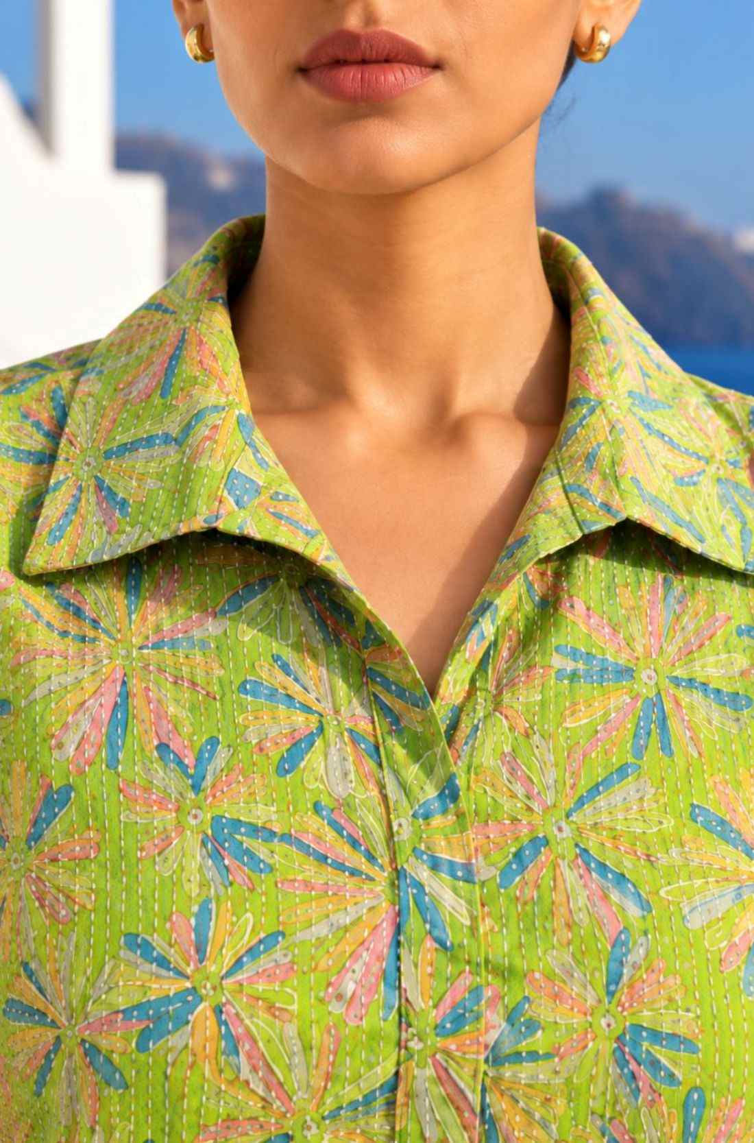 Close-up view of collar neckline and Kantha-style threadwork on a light green pure cotton frock-style kurti for women.