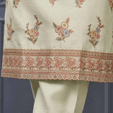 Close-up of floral embroidery and decorative scalloped border on a light green silk blend kurta for women.