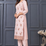 Side view of women’s light pink embroidered silk blend kurta set with matching pants.