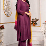 Side view of magenta cotton embroidered A-line kurta set with straight pants and ombre chiffon dupatta.