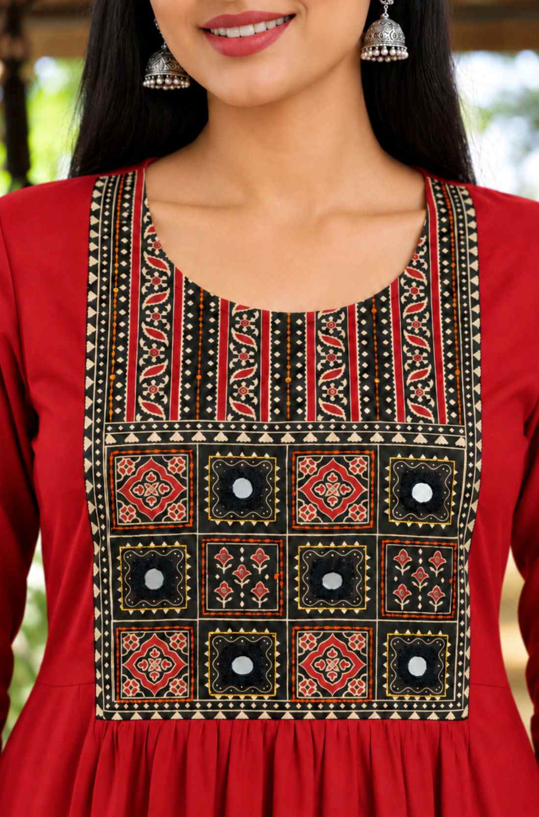 close-up of a maroon rayon kurta showcasing detailed mirror work and a traditional block-printed geometric yoke embroidery design.