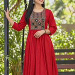A model wearing a full-length maroon rayon A-line kurta featuring 3/4 sleeves and a geometric embroidered yoke