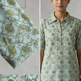 Close-up of mint green hand block print cotton shirt showing floral pattern, wooden buttons, and front design details.