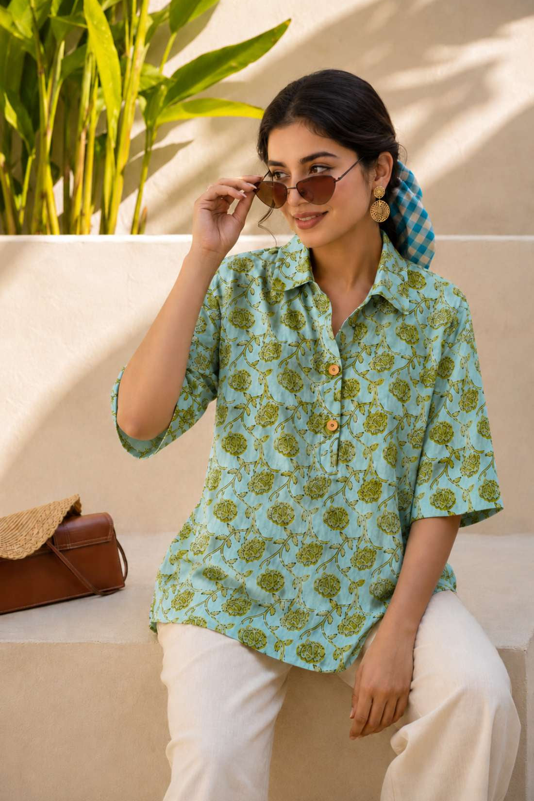 Close-up of mint green hand block print cotton shirt showing floral pattern, wooden buttons, and front design details.