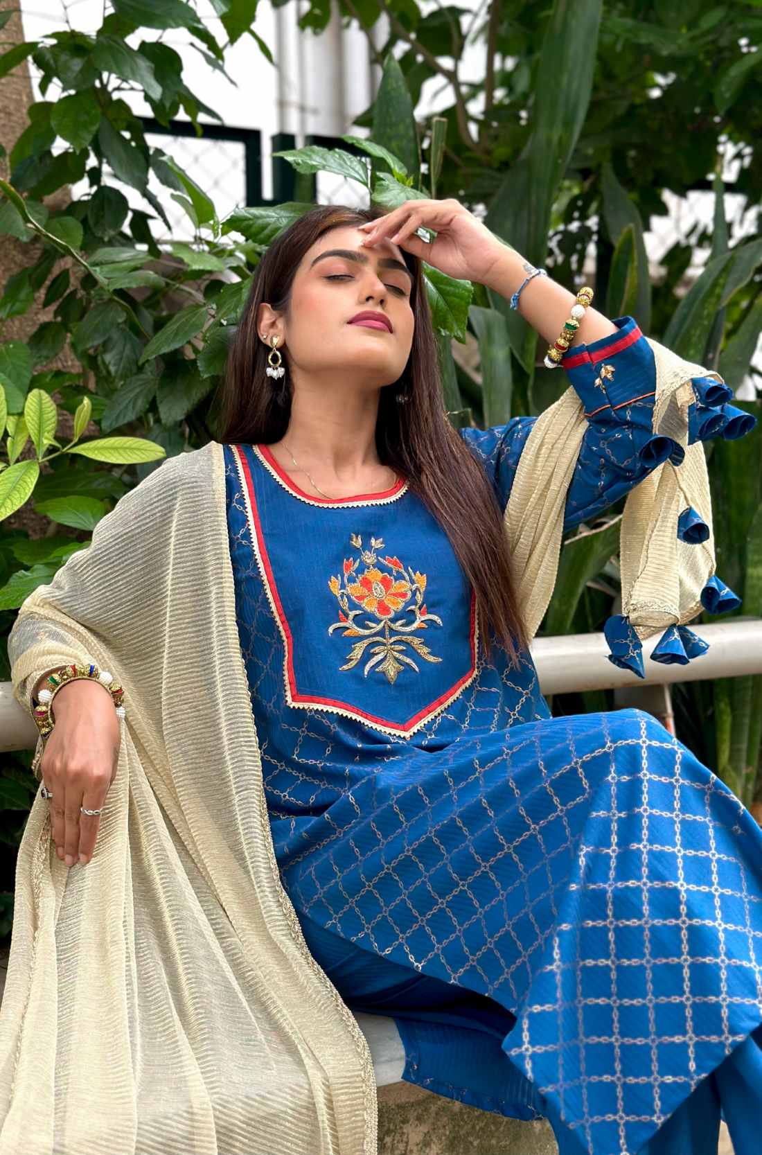 Model sitting in royal blue kurta set showing front view