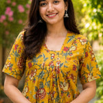 Detailed close-up of the front bodice highlighting the overlapping V-neckline cut and centered pleat gathering on an mustard yellow floral printed cotton kurti dress.