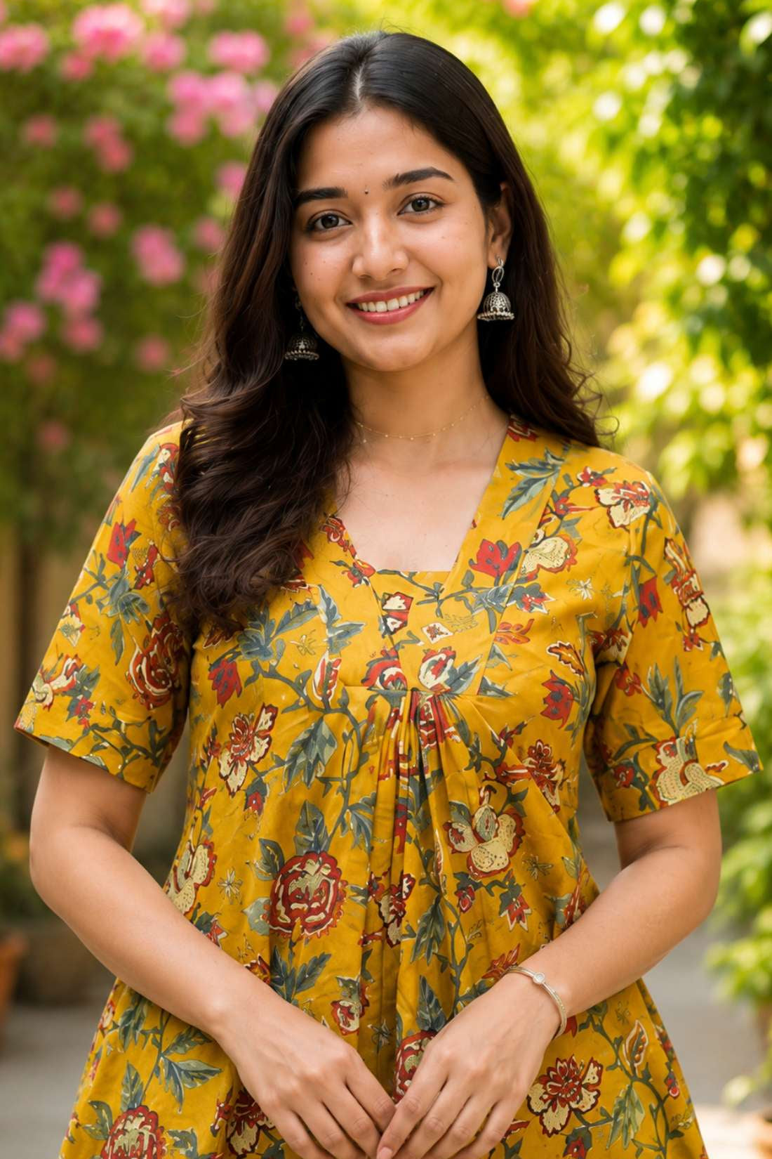 Detailed close-up of the front bodice highlighting the overlapping V-neckline cut and centered pleat gathering on an mustard yellow floral printed cotton kurti dress.