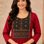 Close-up of the embroidered yoke and round neckline on a maroon rayon kurta