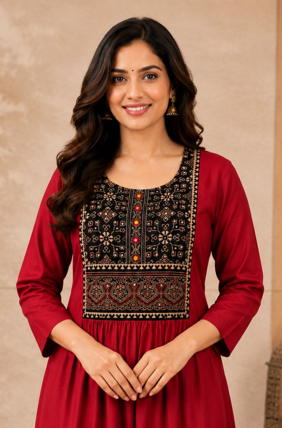 Close-up of the embroidered yoke and round neckline on a maroon rayon kurta