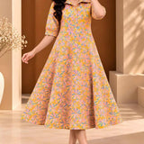 Full-length front view of ochre yellow floral printed pure cotton midi dress for women with a collared neckline and flowing A-line shape.