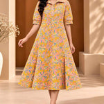 Front view of ochre yellow Jaipur floral print pure cotton A-line midi dress for women with collared neckline and elbow-length sleeves.